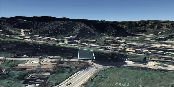 a view of a mountain with a field
