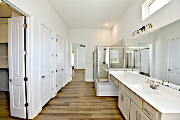 a bathroom with a double vanity sink and mirror