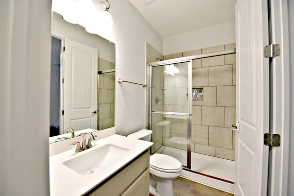 a bathroom with a sink toilet and shower