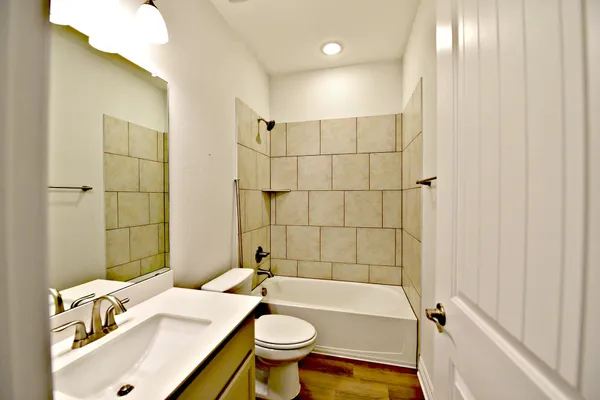a bathroom with a sink toilet and shower