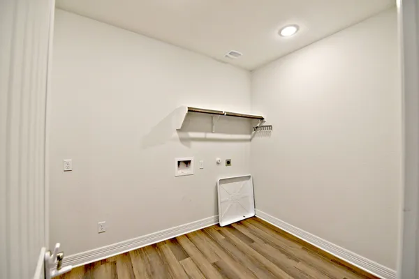 a view of room with wooden floor