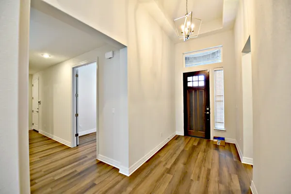 a view of a room with wooden floor and stairs