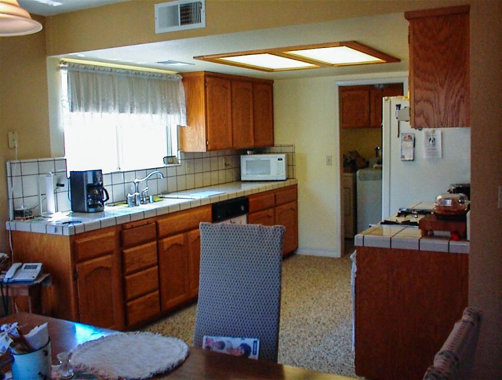 32860 George Smith Road Squaw Valley, CA 93675 - Photo 15 of 35 a kitchen with stainless steel appliances granite countertop a sink and a refrigerator
