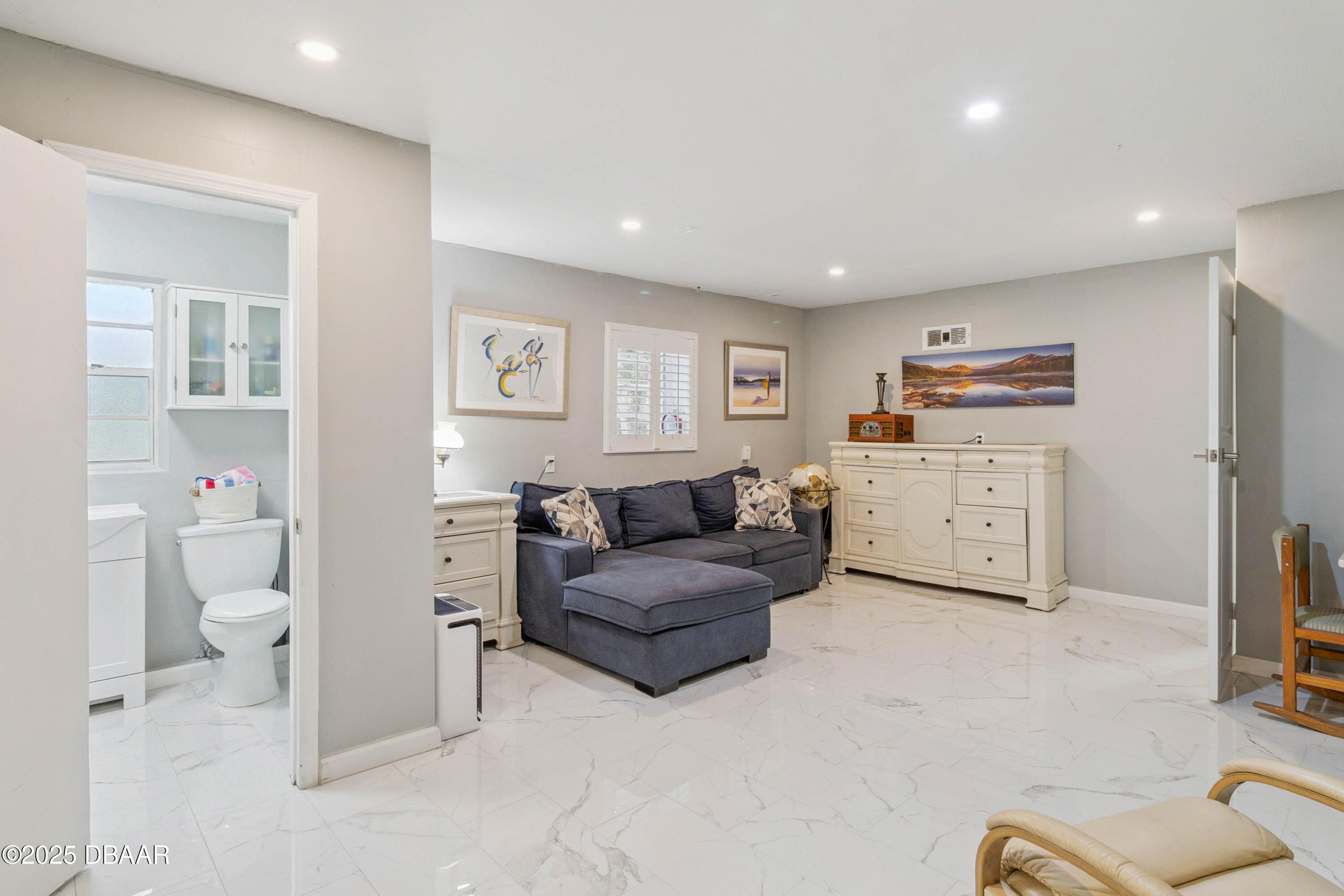 4191 Corey Road Grant Valkaria, FL 32950 - Photo 27 of 55 a living room with furniture and a flat screen tv