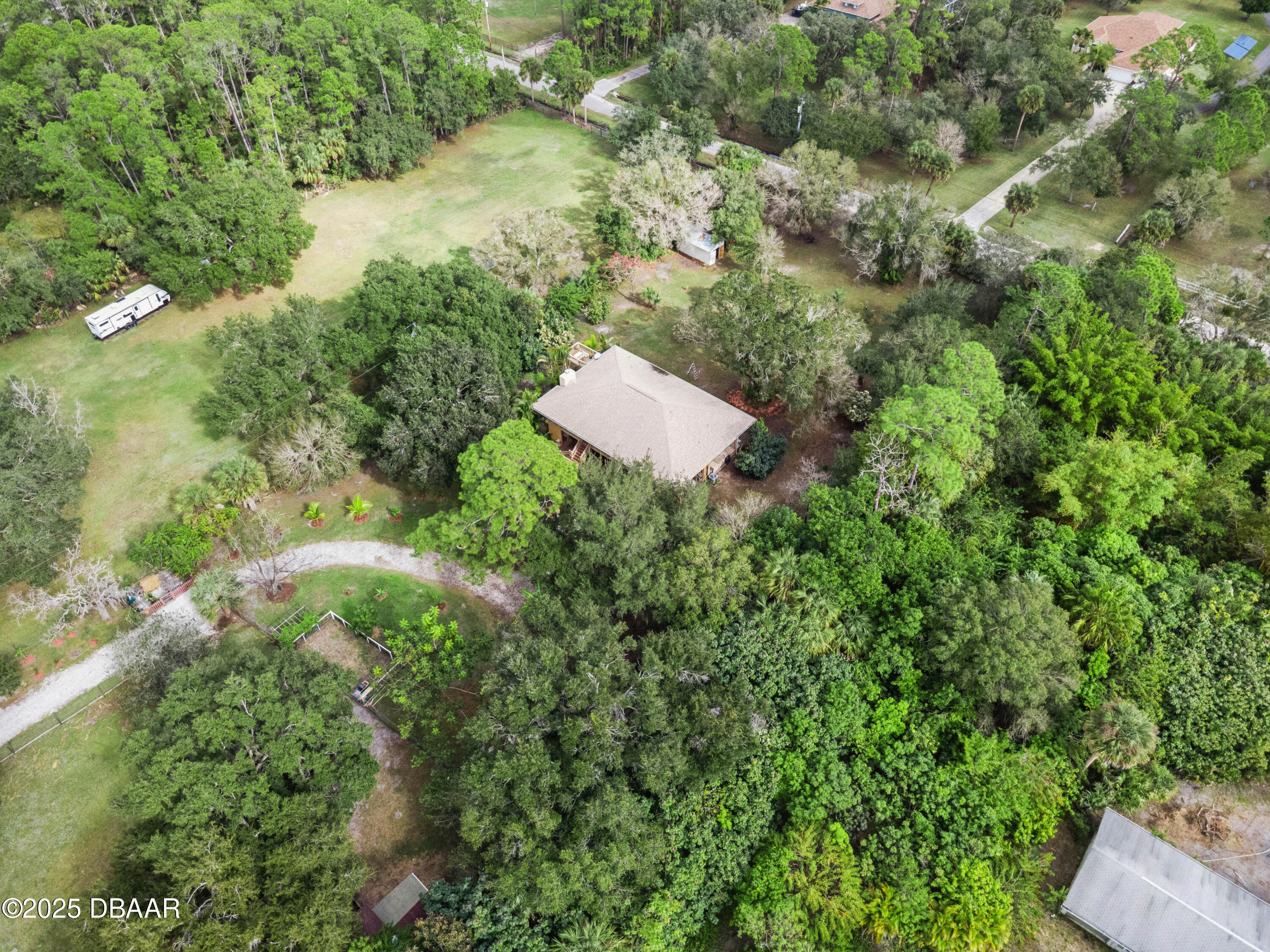 4191 Corey Road Grant Valkaria, FL 32950 - Photo 53 of 55 an aerial view of residential house with outdoor space and trees all around