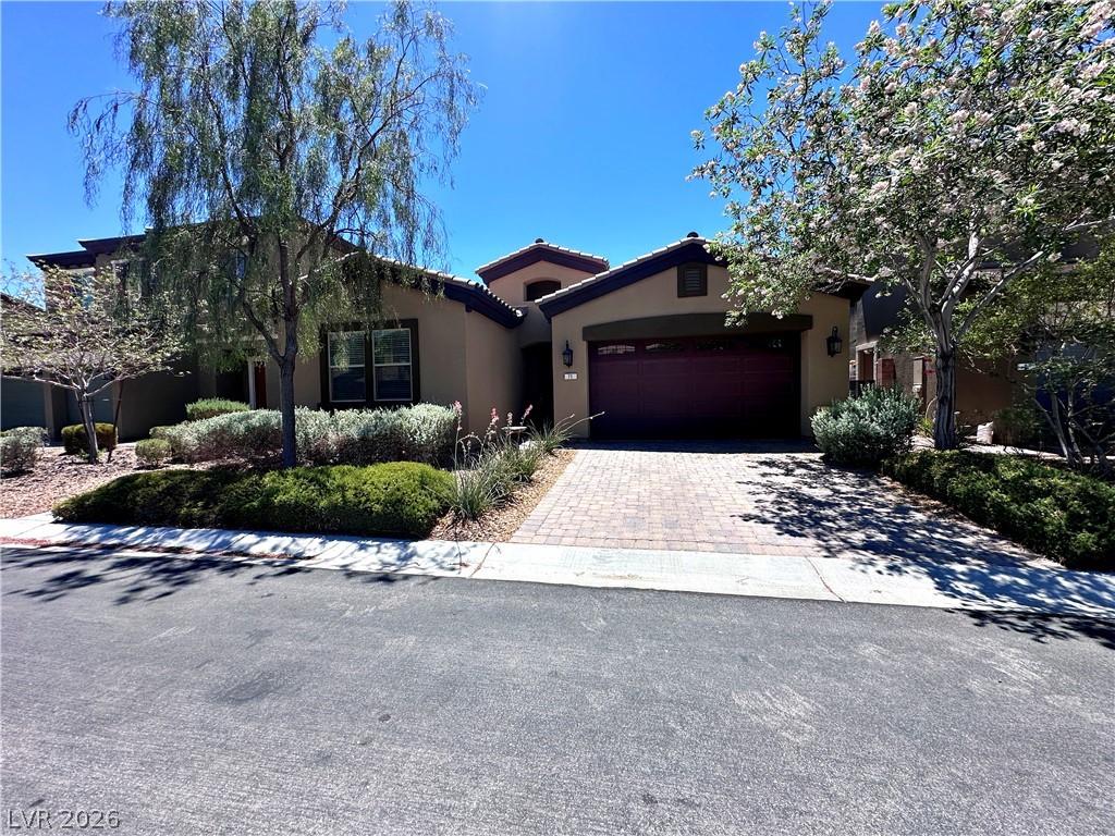 71 Newton Ridge Way Las Vegas, NV 89183 - Photo 3 of 40 An inviting facade with mature trees and thoughtful landscaping welcomes you home.