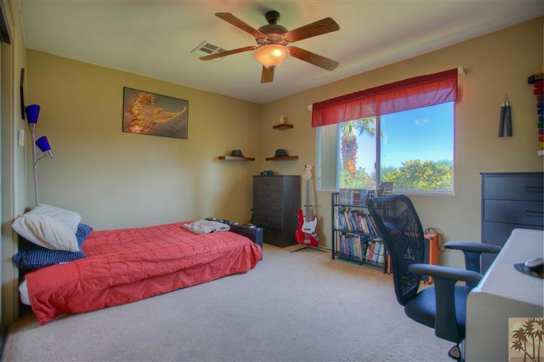 71339 Sahara Road Rancho Mirage, CA 92270 - Photo 11 of 18 a bedroom with a bed and a chandelier