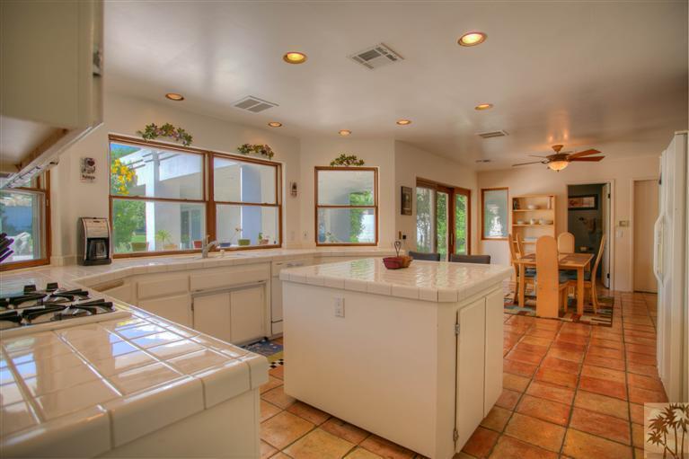 71339 Sahara Road Rancho Mirage, CA 92270 - Photo 6 of 18 a kitchen with stainless steel appliances granite countertop a sink and cabinets