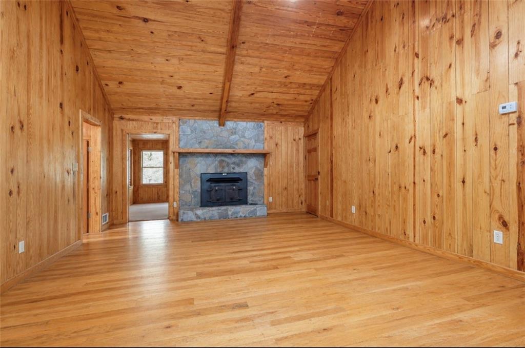 7505 Hall Road Fairburn, GA 30213 - Photo 12 of 43 a view of empty room with wooden floor and fireplace