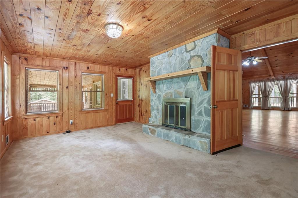 7505 Hall Road Fairburn, GA 30213 - Photo 18 of 43 an empty room with wooden floor and a fireplace