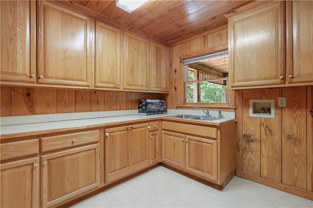 7505 Hall Road Fairburn, GA 30213 - Photo 20 of 43 a kitchen with granite countertop white cabinets and white appliances