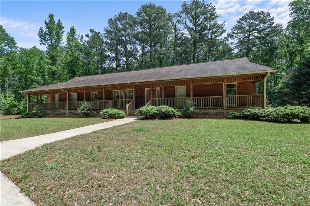 7505 Hall Road Fairburn, GA 30213 - Photo 2 of 43 a view of a house with yard and garden