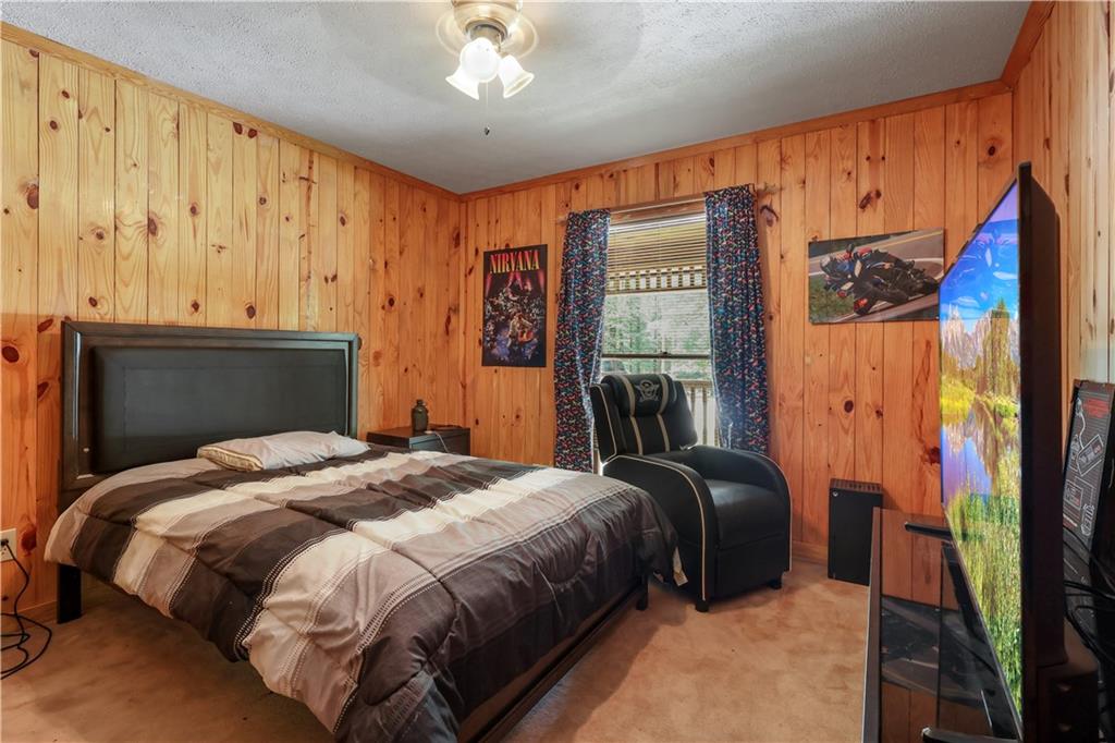 7505 Hall Road Fairburn, GA 30213 - Photo 24 of 43 a bedroom with a bed and wooden floor