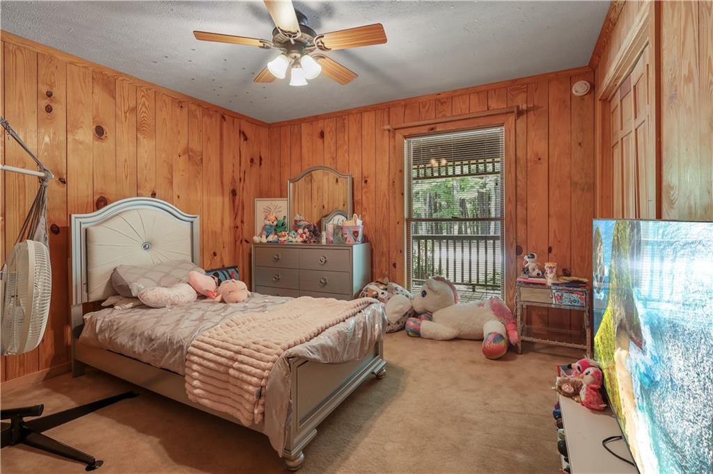 7505 Hall Road Fairburn, GA 30213 - Photo 27 of 43 a bedroom with a bed and a chandelier
