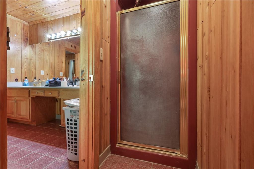 7505 Hall Road Fairburn, GA 30213 - Photo 28 of 43 a bathroom with a mirror and a shower