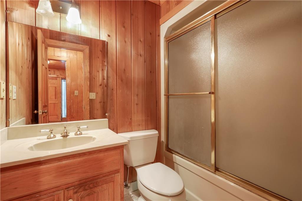 7505 Hall Road Fairburn, GA 30213 - Photo 30 of 43 a bathroom with a sink a toilet a mirror and shower