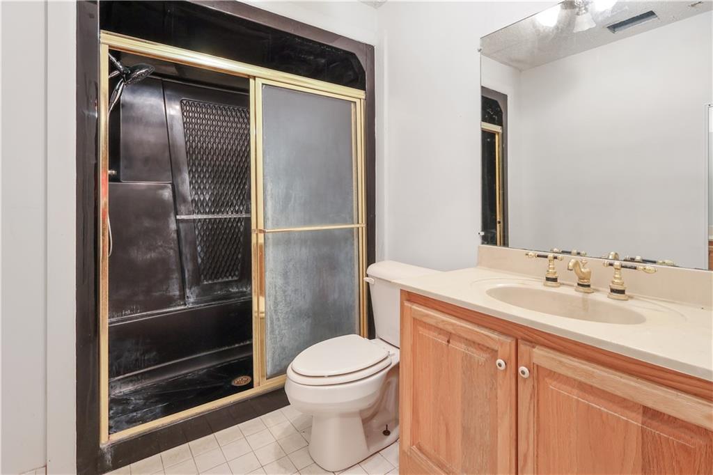 7505 Hall Road Fairburn, GA 30213 - Photo 31 of 43 a bathroom with a sink a toilet and shower