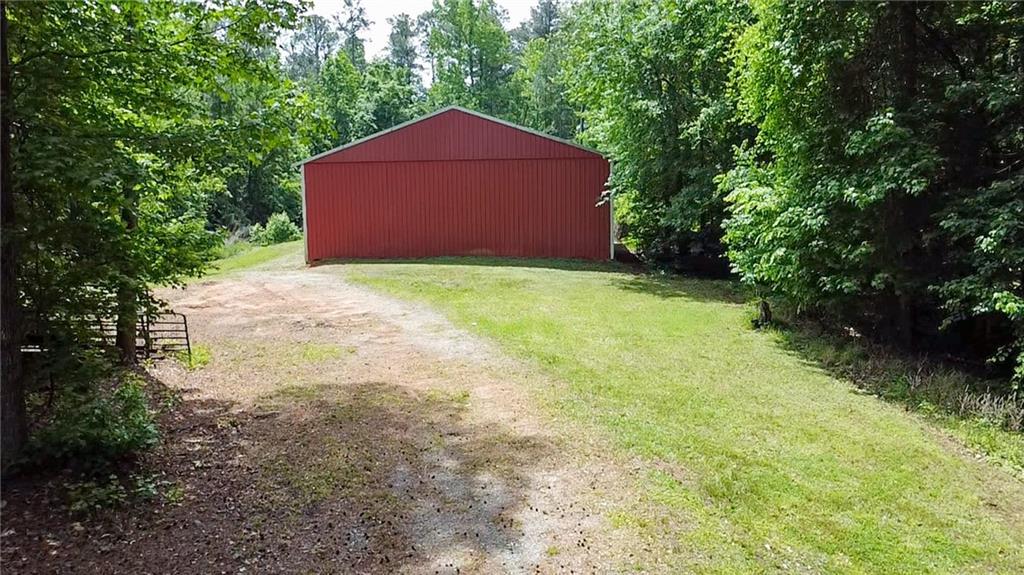 7505 Hall Road Fairburn, GA 30213 - Photo 37 of 43 a house is sitting in middle of the forest