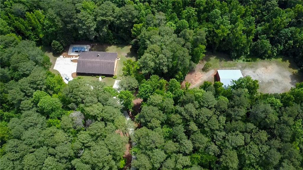 7505 Hall Road Fairburn, GA 30213 - Photo 40 of 43 an aerial view of a house with outdoor space and trees all around