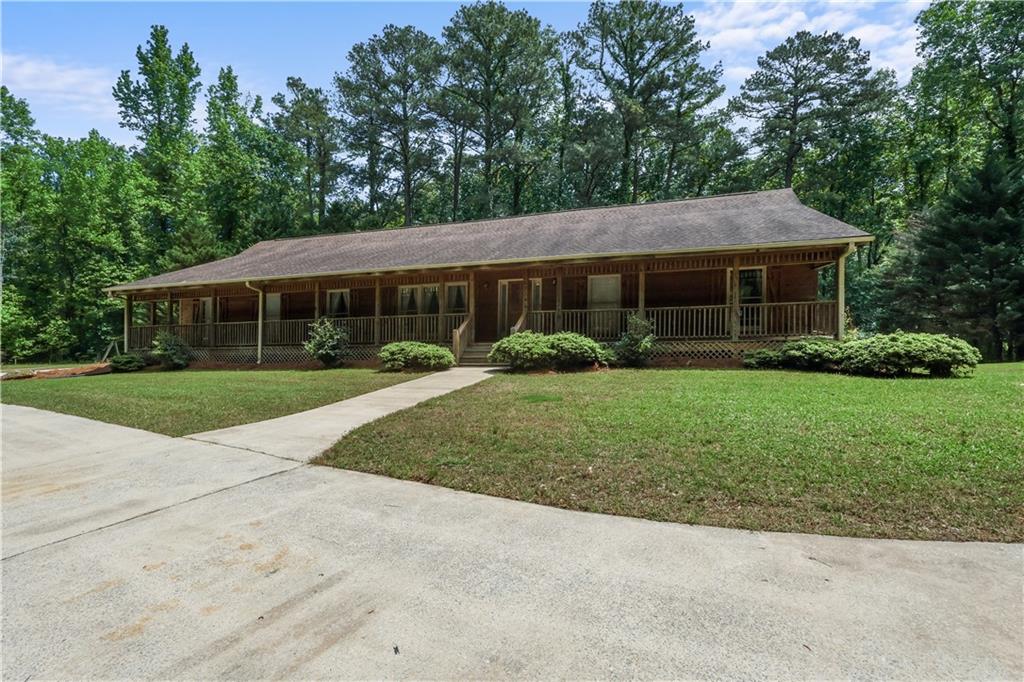 7505 Hall Road Fairburn, GA 30213 - Photo 4 of 43 a front view of house with yard and green space