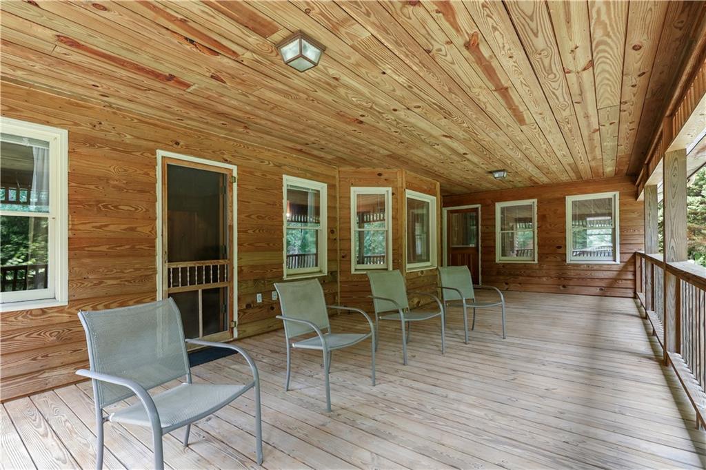 7505 Hall Road Fairburn, GA 30213 - Photo 10 of 43 a dining room with wooden floor and outdoor seating