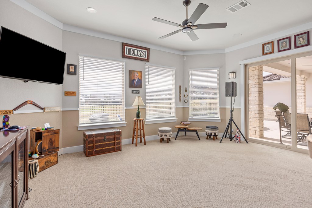 2085 Toscano Way Kerrville, TX 78028 - Photo 17 of 36 a view of living room with furniture and a flat screen tv