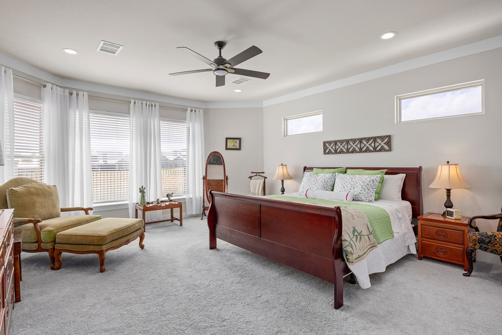 2085 Toscano Way Kerrville, TX 78028 - Photo 19 of 36 a spacious bedroom with a bed and a couch