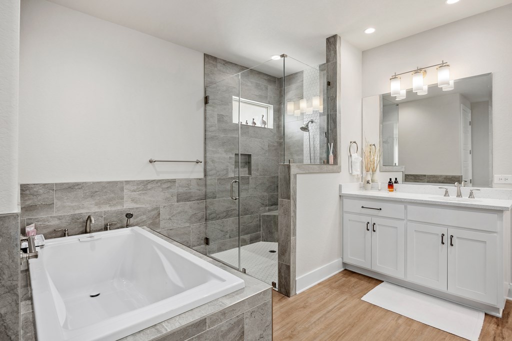 2085 Toscano Way Kerrville, TX 78028 - Photo 21 of 36 a bathroom with a bathtub sink and mirror