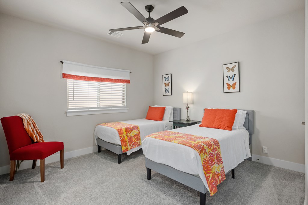 2085 Toscano Way Kerrville, TX 78028 - Photo 27 of 36 a bedroom with two beds and a chair