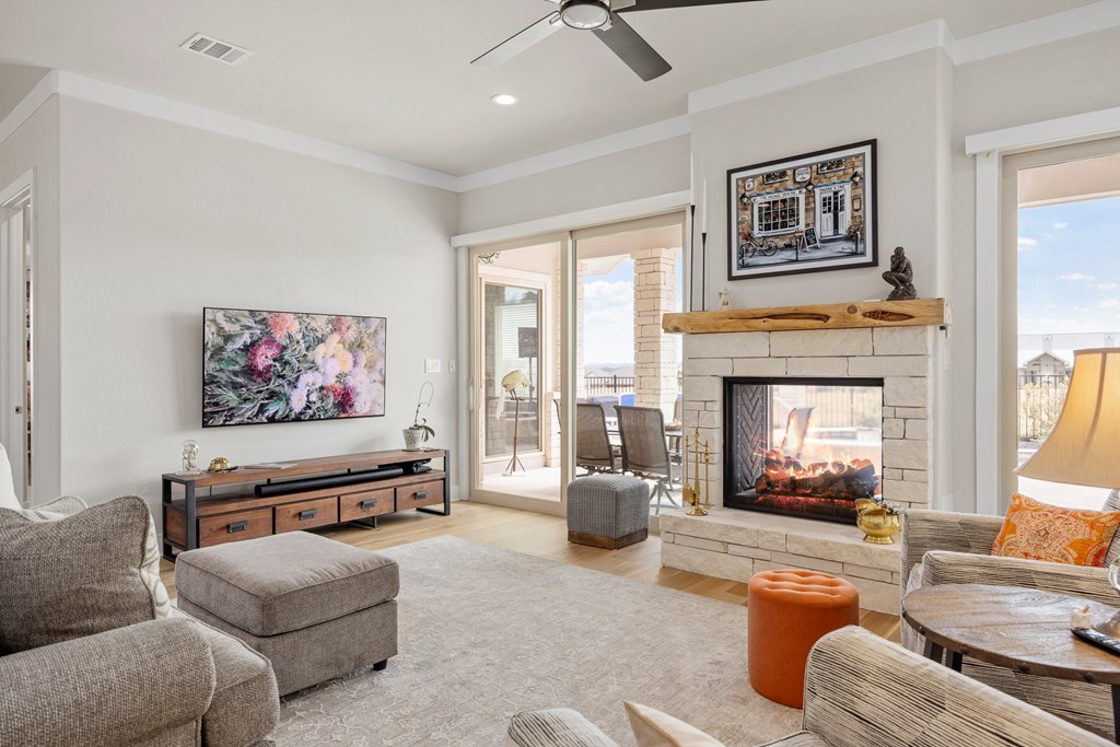 2085 Toscano Way Kerrville, TX 78028 - Photo 5 of 36 a living room with furniture fireplace and a large window