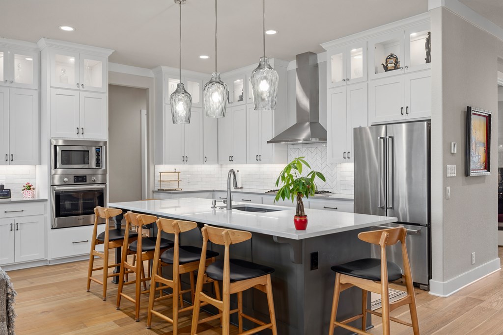 2085 Toscano Way Kerrville, TX 78028 - Photo 8 of 36 a kitchen with stainless steel appliances a dining table chairs stove refrigerator and microwave