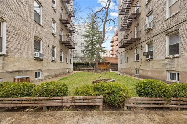 a front view of a building with a garden