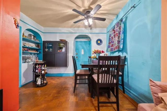 a view of a dining room with furniture and a chandelier