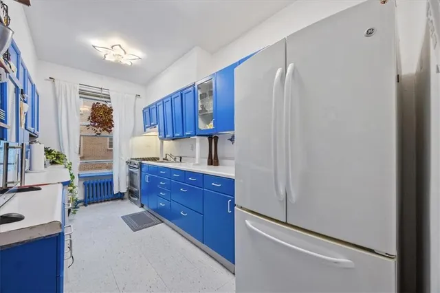a kitchen with a refrigerator and a sink