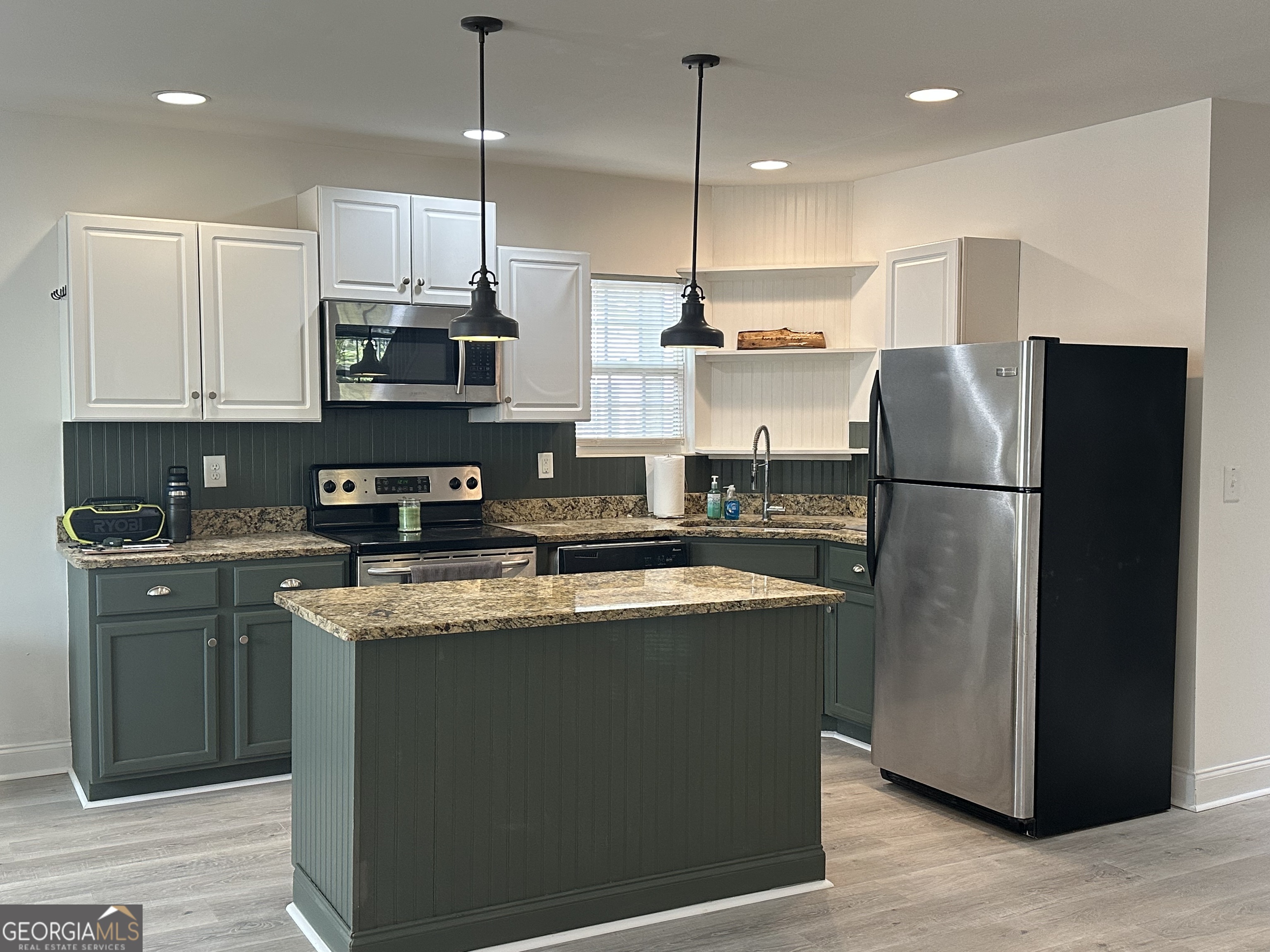 3114 The Trail Road Gainesville, GA 30501 - Photo 15 of 32 a kitchen with stainless steel appliances granite countertop a refrigerator a stove a sink and a center island