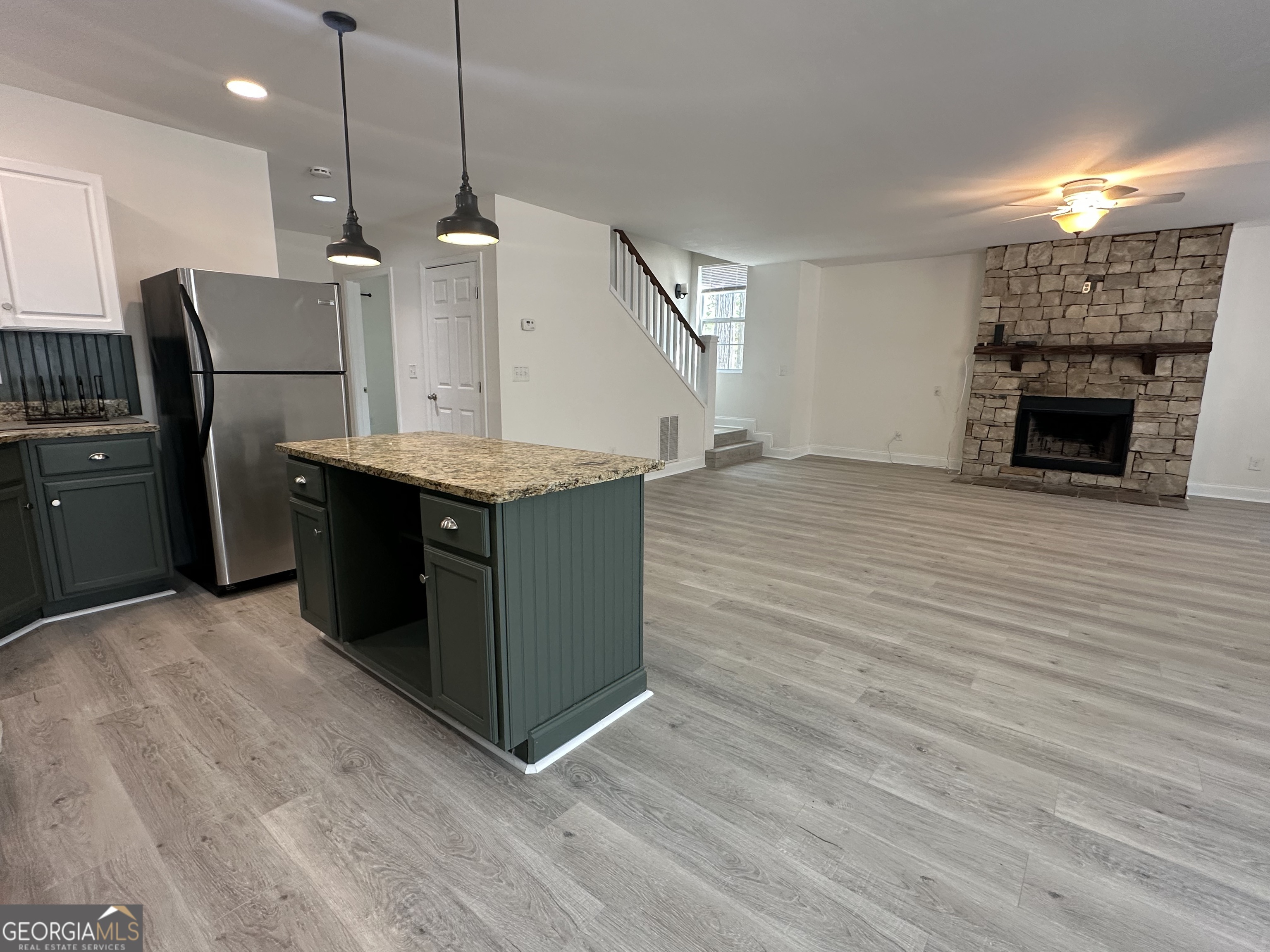 3114 The Trail Road Gainesville, GA 30501 - Photo 18 of 32 a kitchen with stainless steel appliances granite countertop a sink a stove and a wooden floors