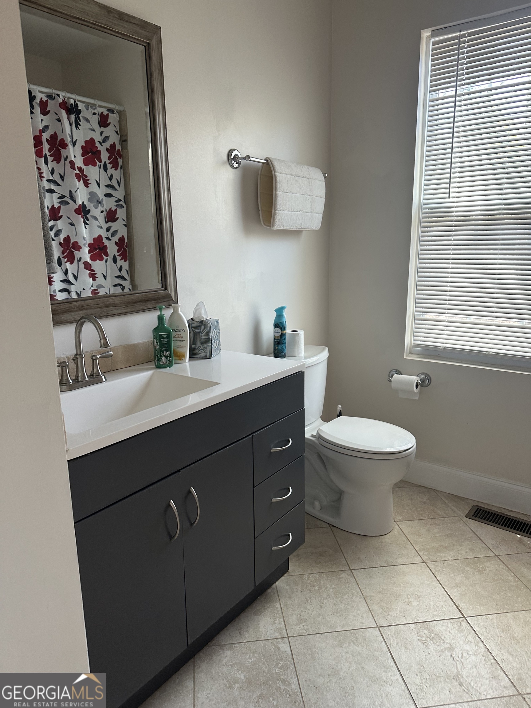 3114 The Trail Road Gainesville, GA 30501 - Photo 19 of 32 a bathroom with a toilet sink and mirror