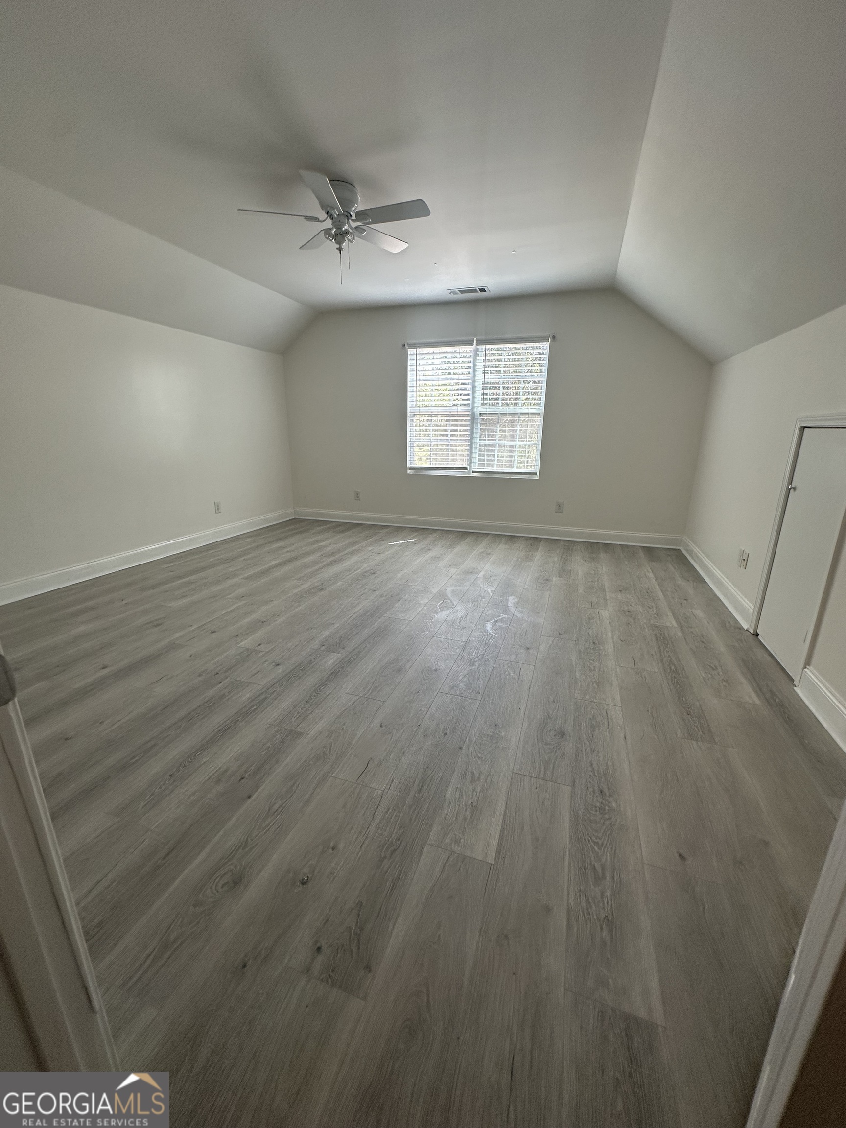3114 The Trail Road Gainesville, GA 30501 - Photo 26 of 32 an empty room with wooden floor and windows