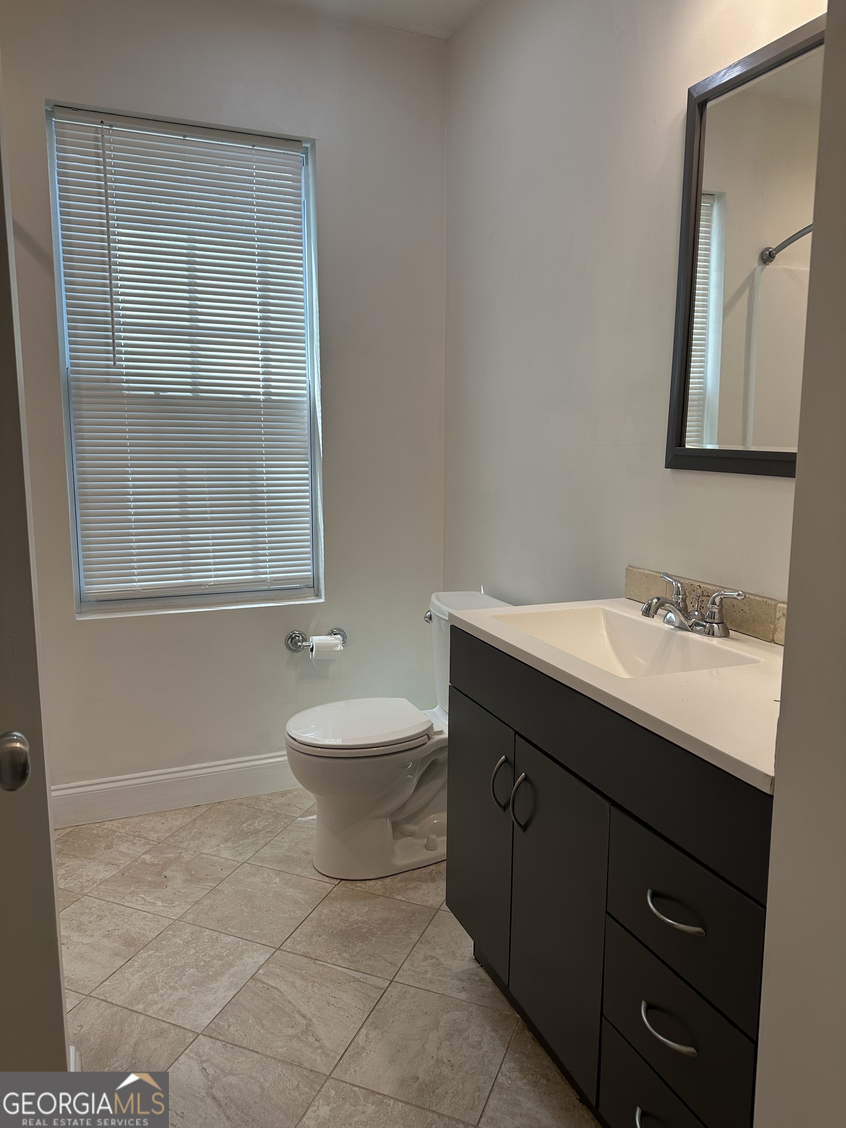 3114 The Trail Road Gainesville, GA 30501 - Photo 30 of 32 a bathroom with a sink a toilet and mirror
