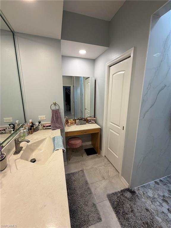 7791 Grande Pine Road Bokeelia, FL 33922 - Photo 24 of 45 a bathroom with a sink a toilet and a mirror
