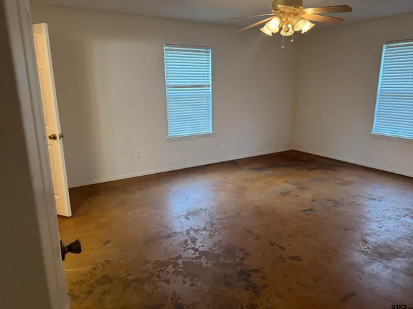a bathroom with a toilet a sink a tub and mirror
