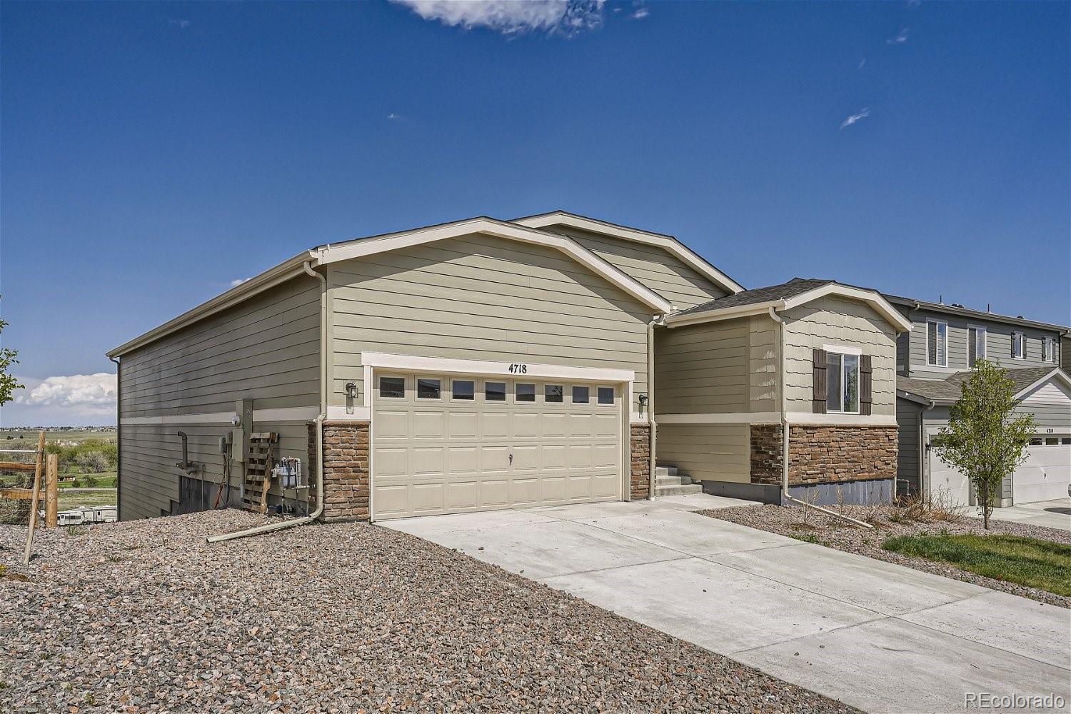4718 River Highlands Loop Elizabeth, CO 80107 - Photo 1 of 28 a front view of a house with a yard