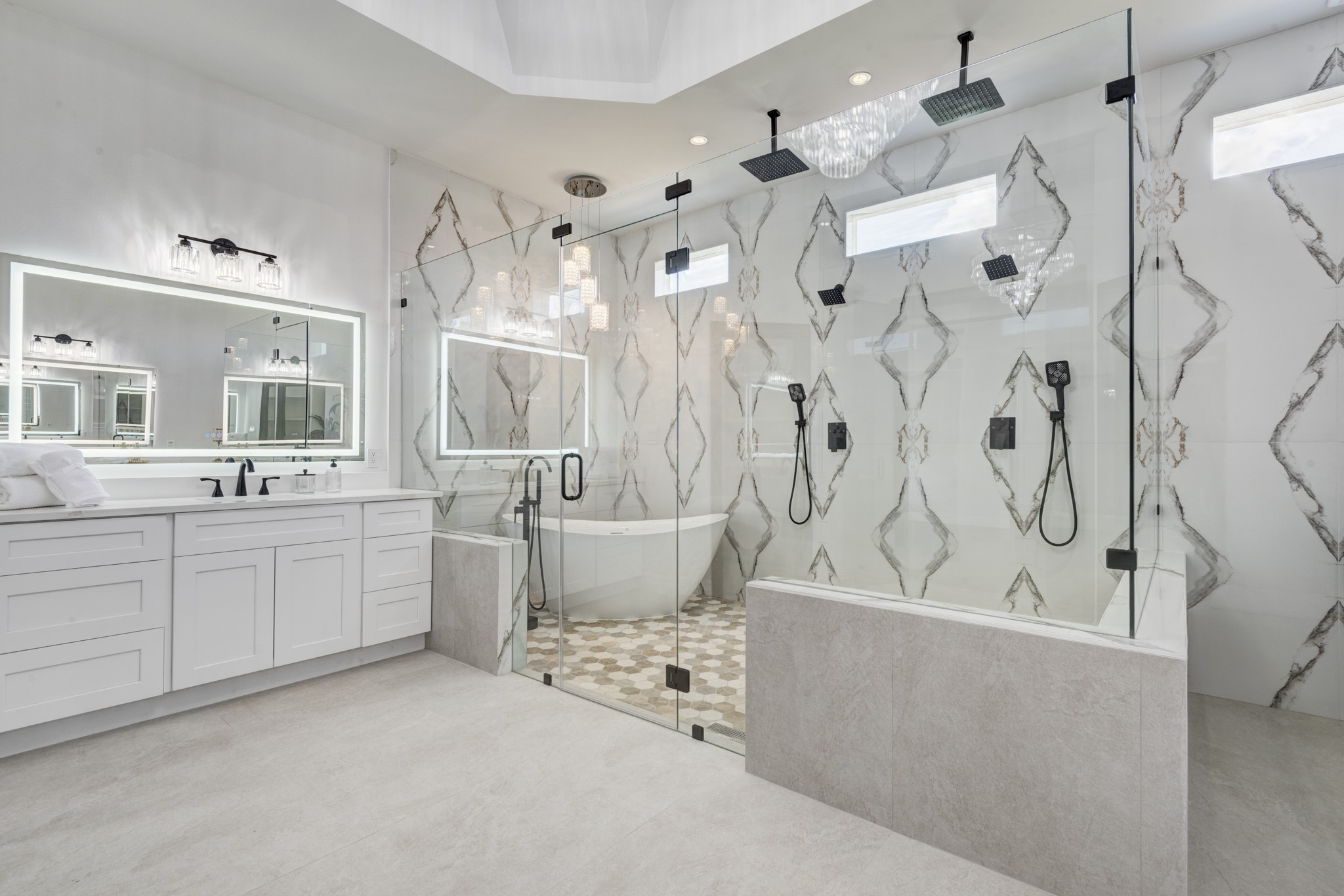 7348 Love Road Fulshear, TX 77441 - Photo 34 of 48 Indulge in luxury with this master bathroom, featuring an expansive glass-enclosed shower, elegant dual vanities, and sophisticated tile work for a spa-like retreat.