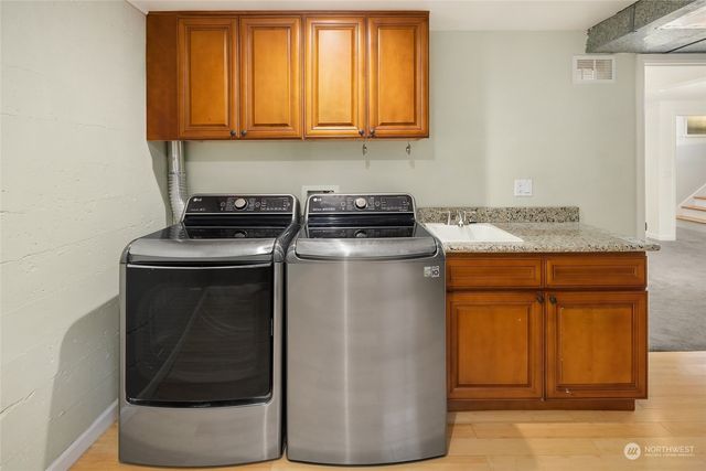 a kitchen with granite countertop cabinets and black stainless steel appliances