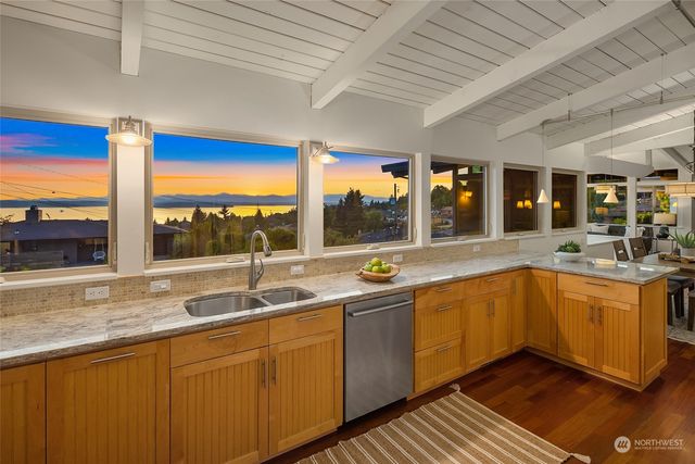 a kitchen with stainless steel appliances granite countertop sink and window