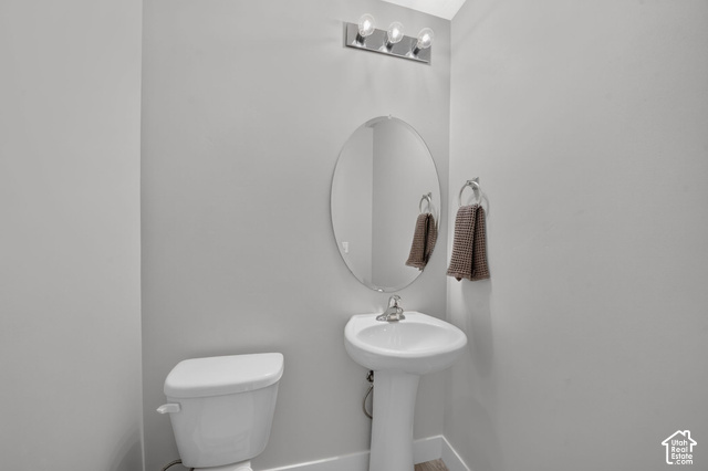 1081 Bowery Way Mapleton, UT 84664 - Photo 16 of 41 Pedestal sink with chrome faucet, oval mirror, and three-bulb vanity light fixture
