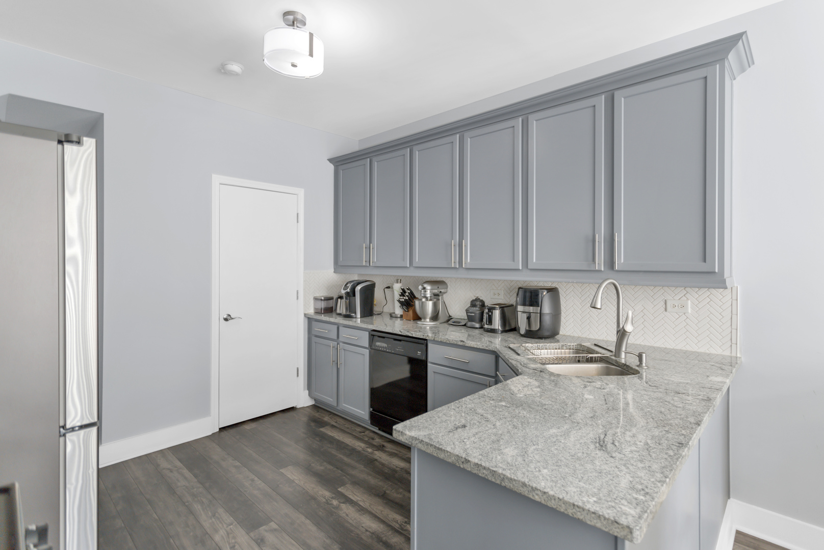 1420 Millbrook Drive Algonquin, IL 60102 - Photo 10 of 28 a kitchen with stainless steel appliances granite countertop a sink dishwasher a stove and a refrigerator with wooden floor