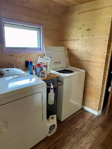 a bedroom with a bed next to a window with a chandelier