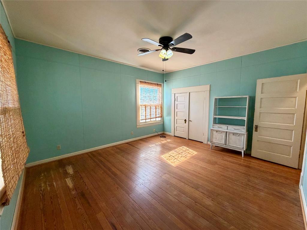 600 Mercer Street Quanah, TX 79252 - Photo 19 of 28 a view of empty room with wooden floor and fan