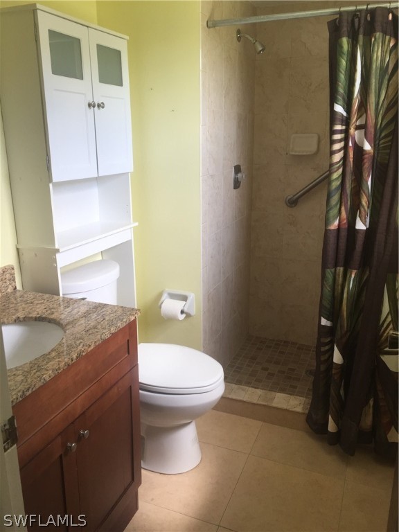 18566 Wisteria Road Fort Myers, FL 33967 - Photo 12 of 15 a bathroom with a granite countertop sink toilet and shower